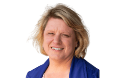 Headshot of Natalie McDonald. Woman with short blonde hair and a blue blazer smiling at the camera.