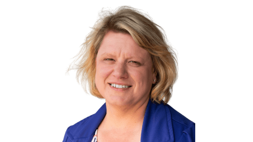 Headshot of Natalie McDonald. Woman with short blonde hair and a blue blazer smiling at the camera.