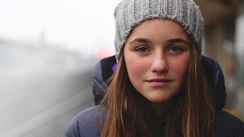 Young girl wearing a beanie and navy jacket