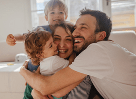 family of 4 hugging