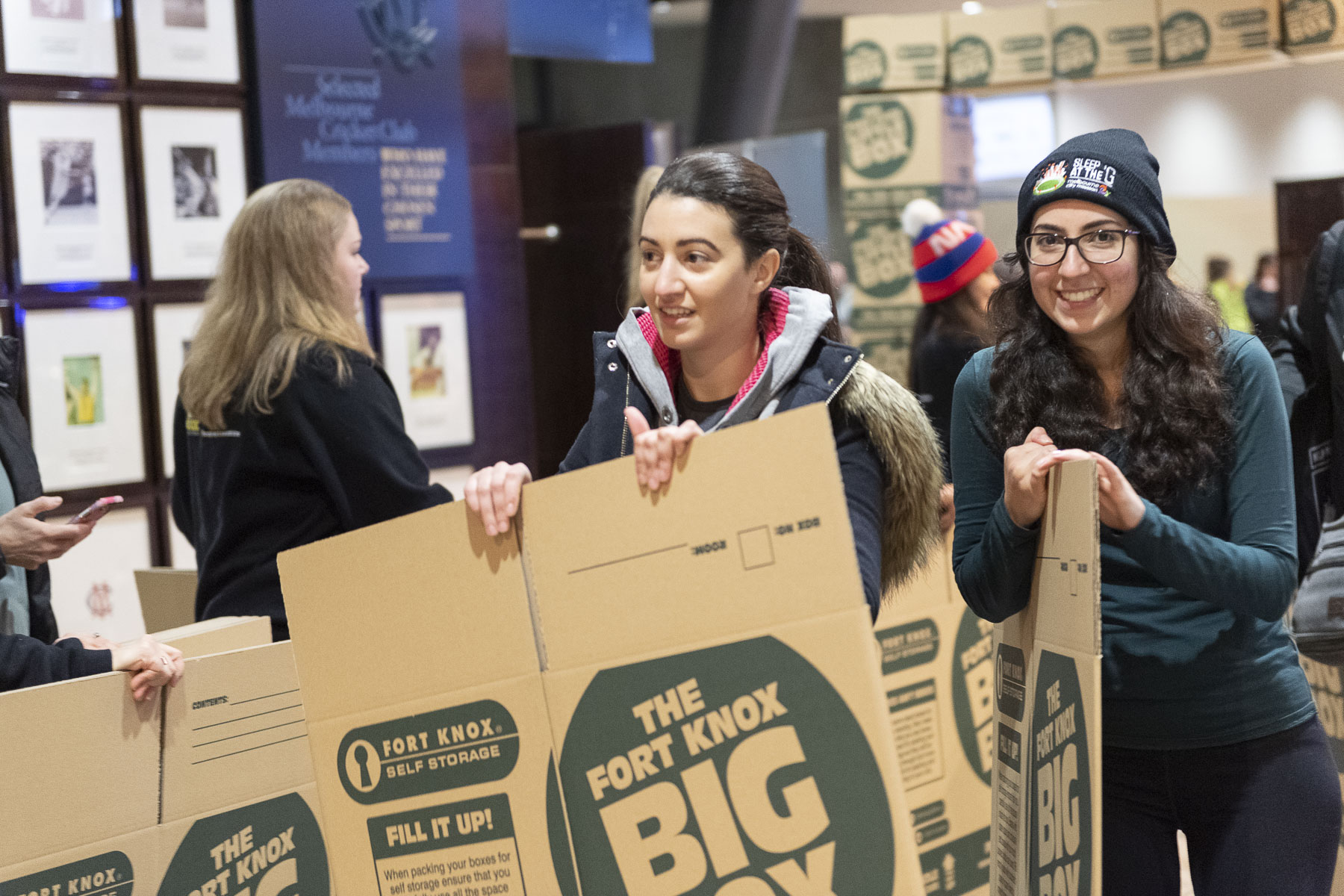 Two young ladies with their cardboard boxes at Sleep At The G