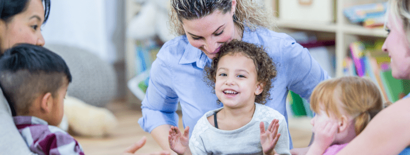 photo of 3 mothers and their children on their laps