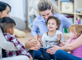 photo of 3 mothers and their children on their laps