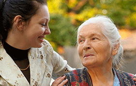 Young female carer smiles at an older lady