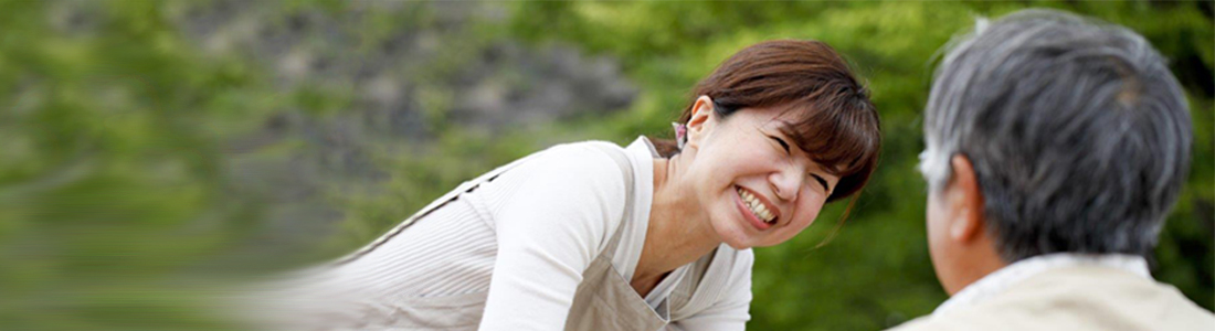 Young Asian lady smiling at a man who is not facing the camera