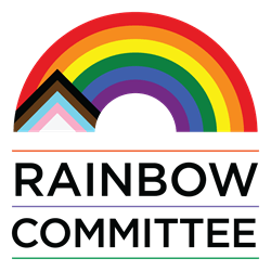 Logo for the Rainbow Committee featuring a stylized rainbow with the Progress Pride flag colors integrated into a house-like shape on the left side. Below the rainbow, the words 'RAINBOW COMMITTEE' are written in bold black uppercase letters, separated by thin horizontal lines in rainbow colours.