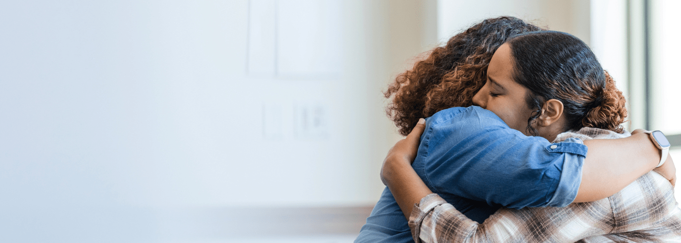 Mother and daughter hugging