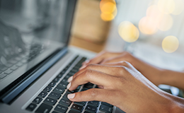 hands typing on a keyboard