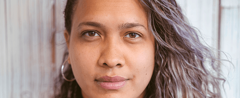 Teenage girl with brown etes and hair looking at the camera