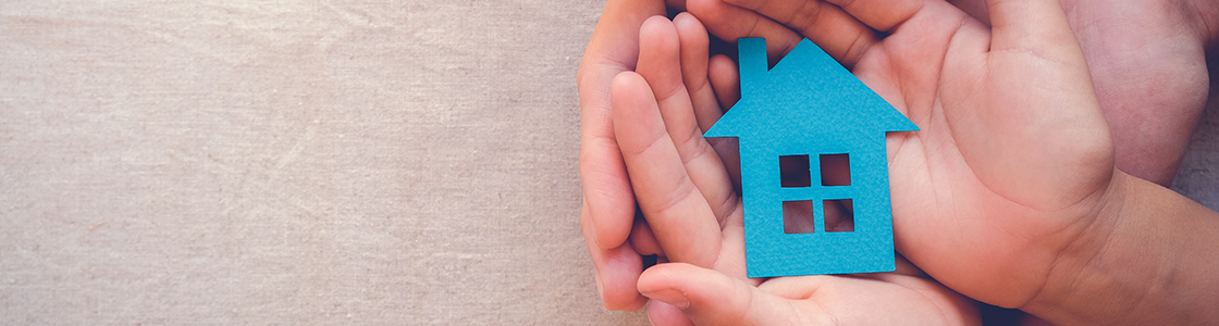 Blue housing icon in someone's hands