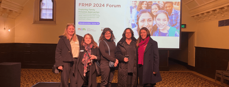 5 women standing on a stage