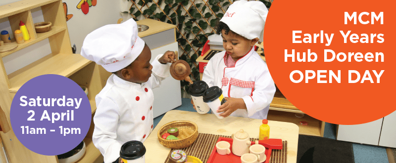 Two young children play together while dressed in a Chef's uniform