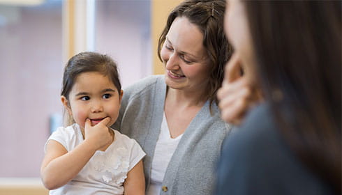 Speech therapity at MCM working with a young girl and her mother