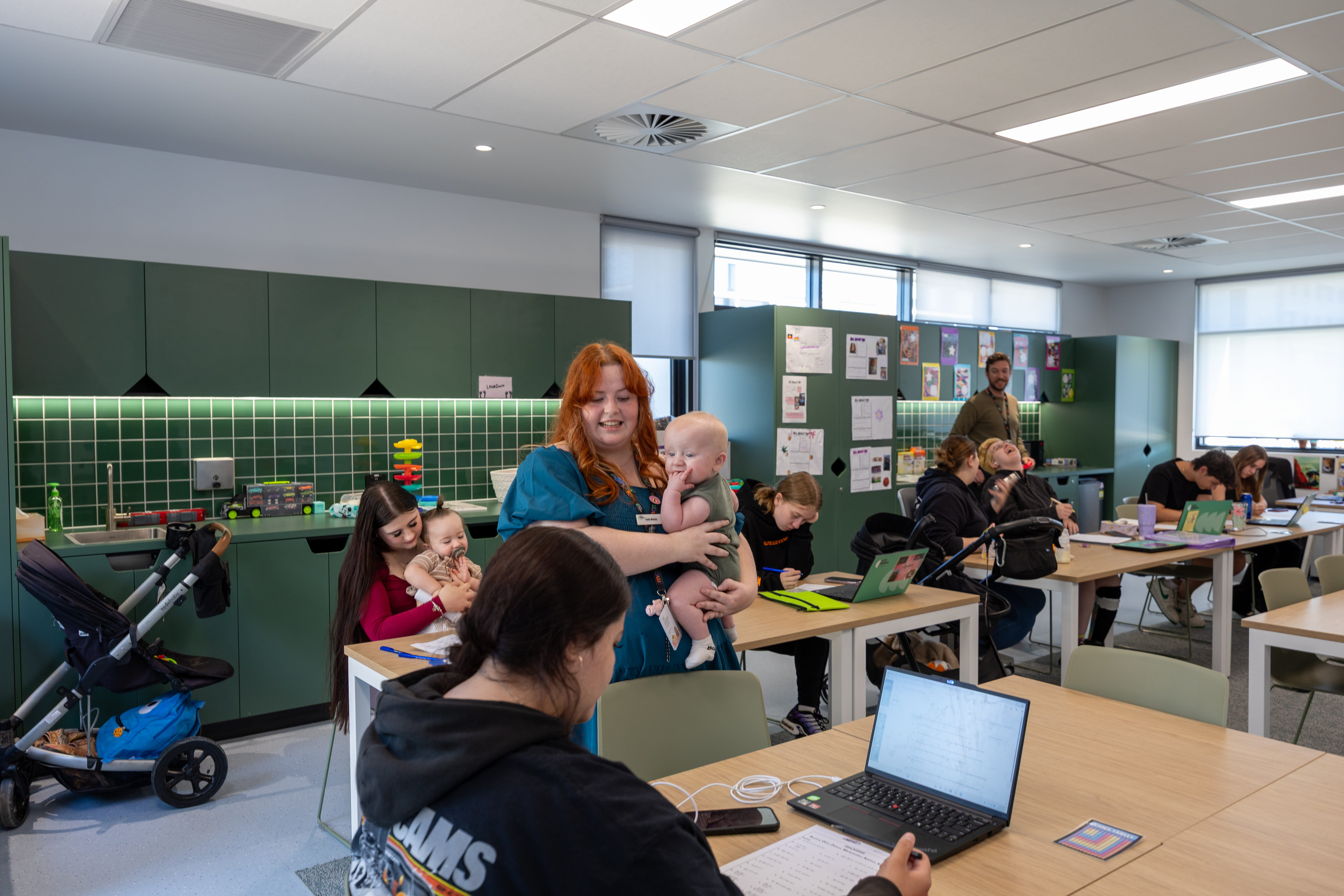 young parents classroom teacher and baby