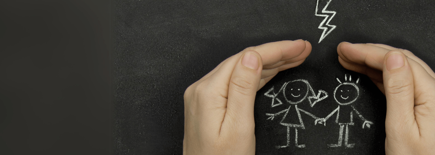 cupped hands over a chalk drawing of a girl and boy smiling and holding hands protected from chalk lightning 
