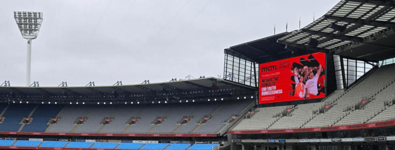 Photo of MCG stands with Sleep At The G on the scoreboard