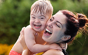 Mum holding her baby son with Down Syndrome