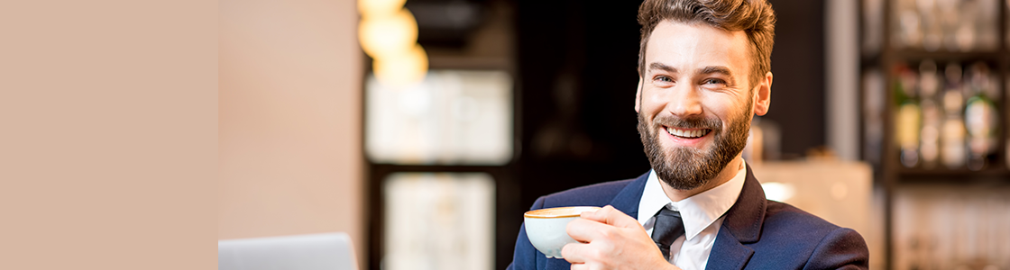 young many smiling at camera drinking cup of coffee