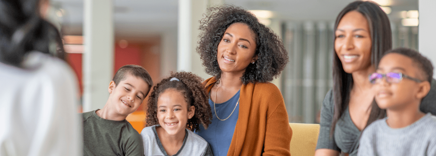 ollie and imogen leaning against brick wall
