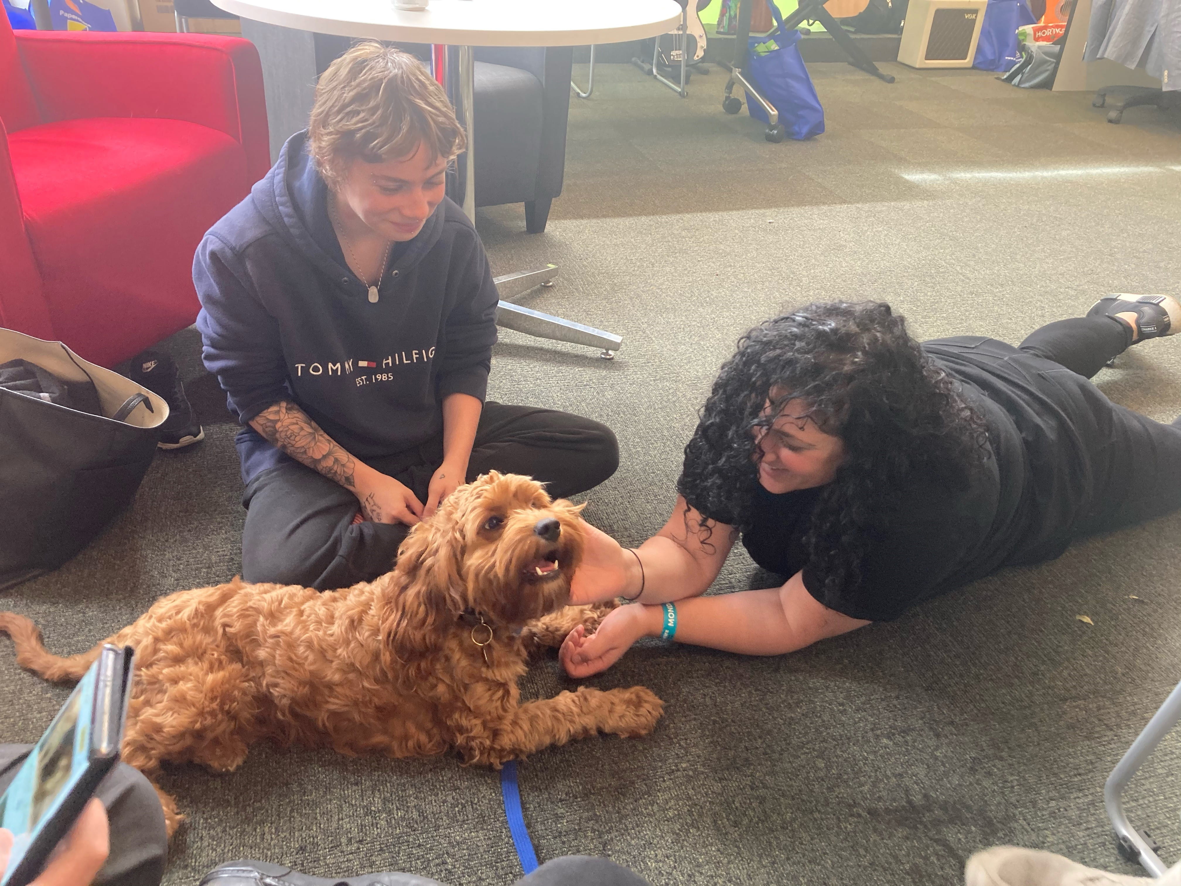 Two HHA staff with dog.