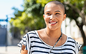 Young female with very short cut hair smiling